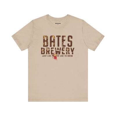 A tan t-shirt with a bold “Bates Brewery” logo and tagline “Beer Like Mother Used to Brew” printed on the front.